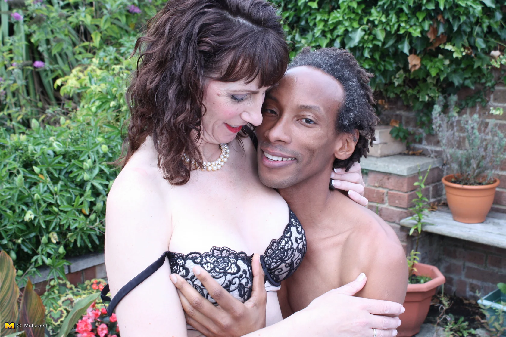 British mom fooling around with a black guy in her garden