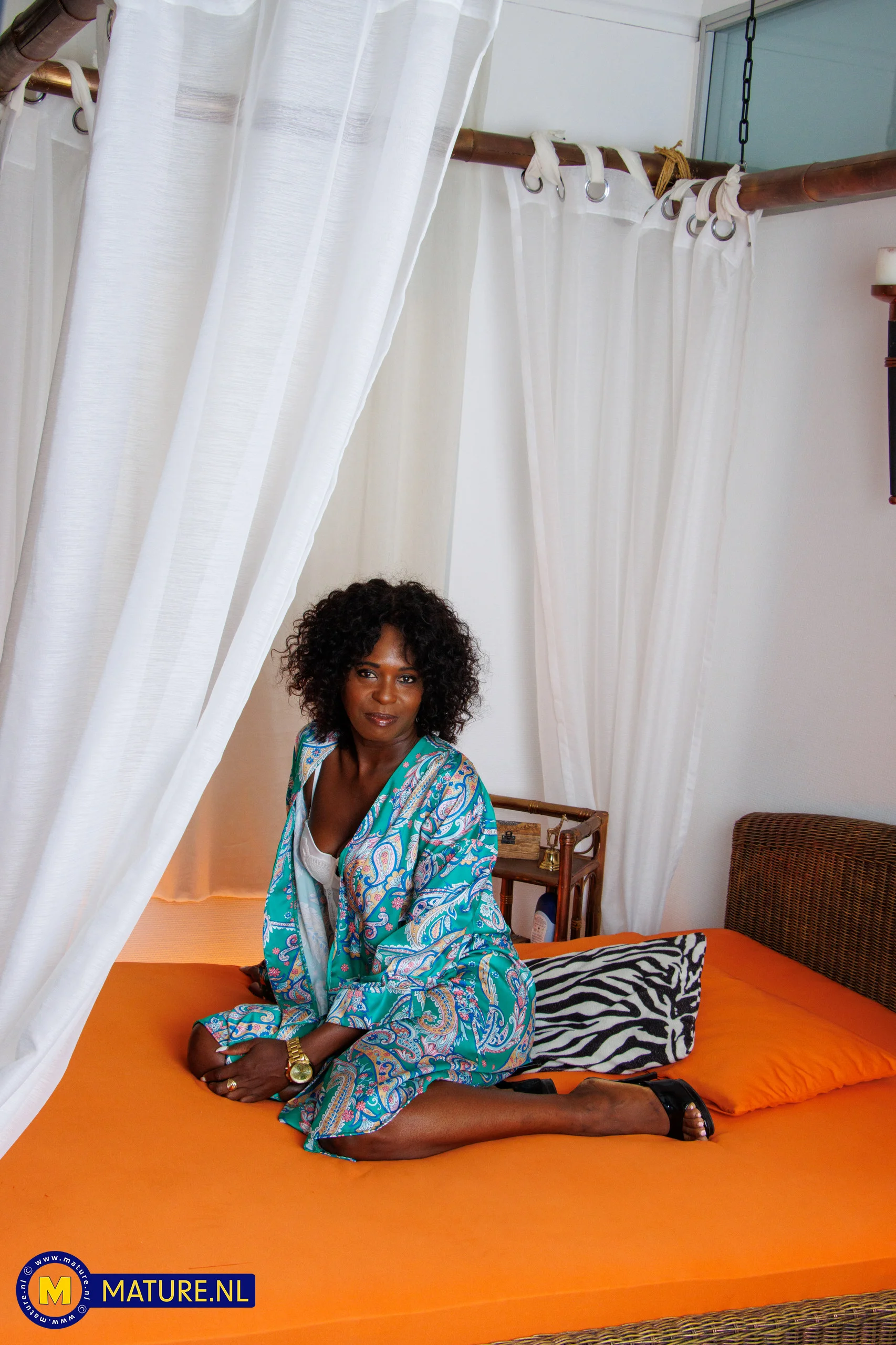 Naomi is a teasing 51 year old black milf with a shaved pussy that loves to masturbate